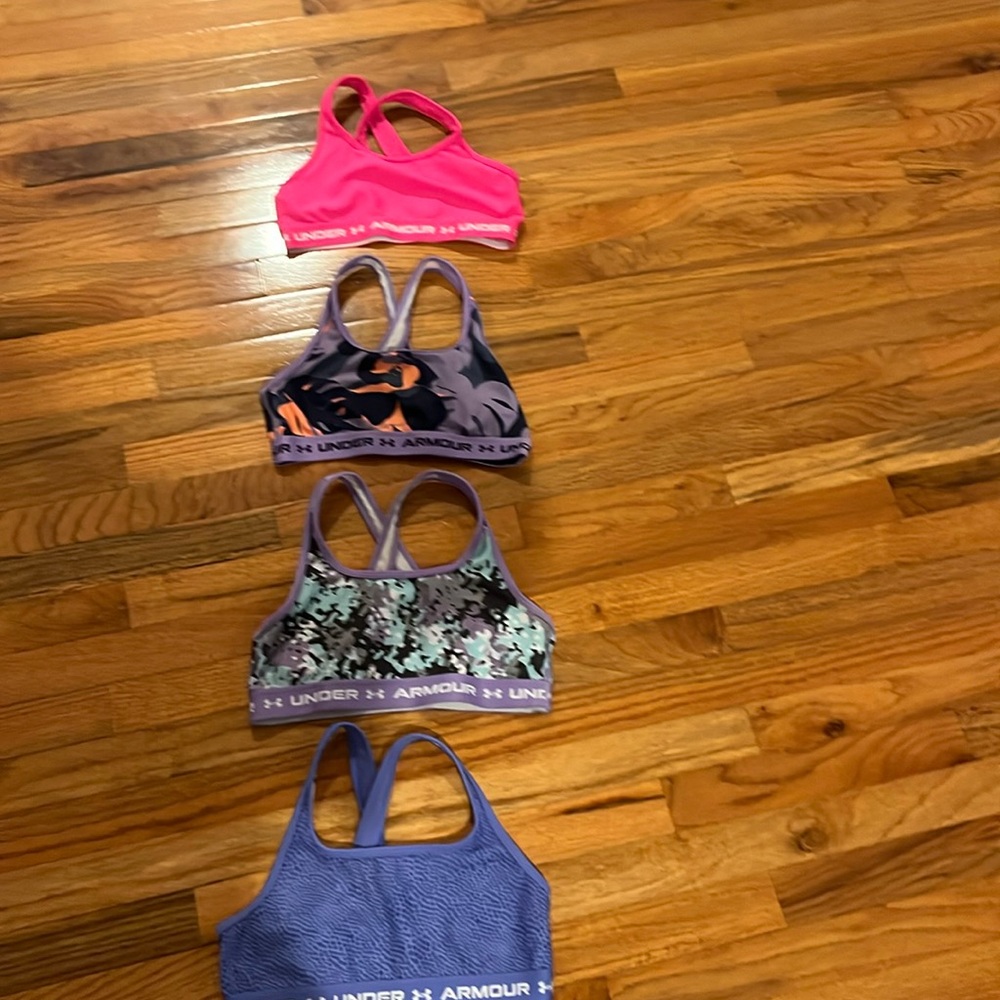 4 bras all crossover in the back with multiple colors and designs in size is YLG